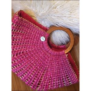 The Sak basket weave bag with wooden handles.